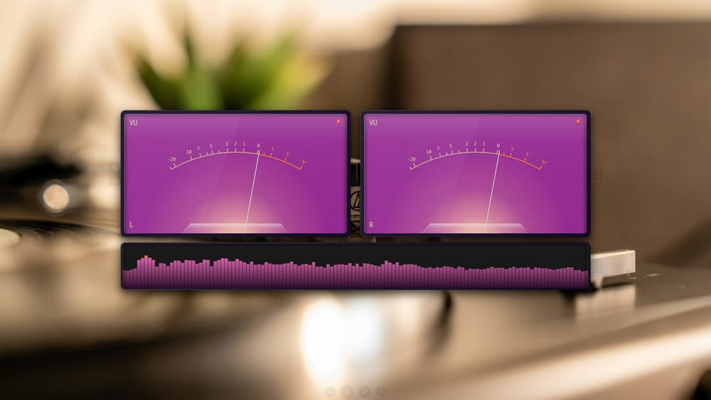 OtoMeter in fullscreen with analog VU meters, spectrum histogram, and a custom backdrop